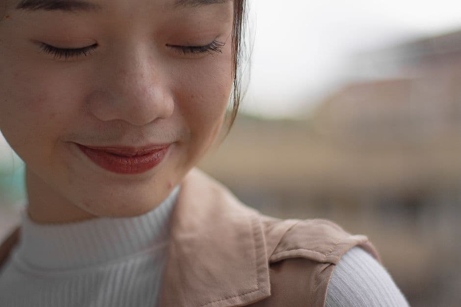 Illustrative image — Portrait of a woman with eyes closed and gentle smile, creating a serene and peaceful mood.