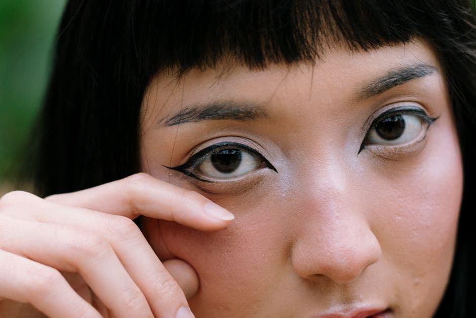Illustrative image — A detailed close-up of a woman's face highlighting bold makeup and intense eye expression.