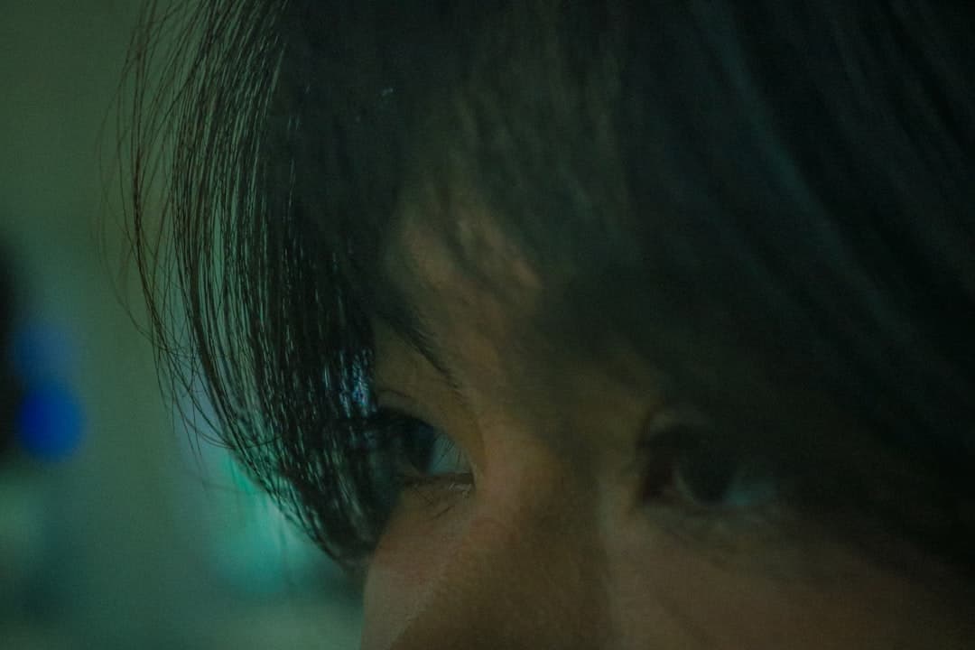 Illustrative image — Eyes focused intently in the dim light.