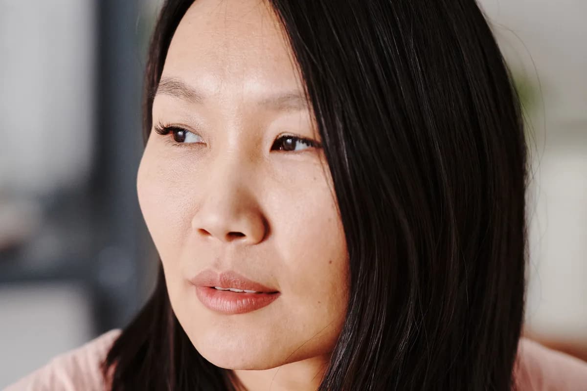 Illustrative image — A mature Asian woman with a bob and a calm expression, three-quarter view against a soft clean interior