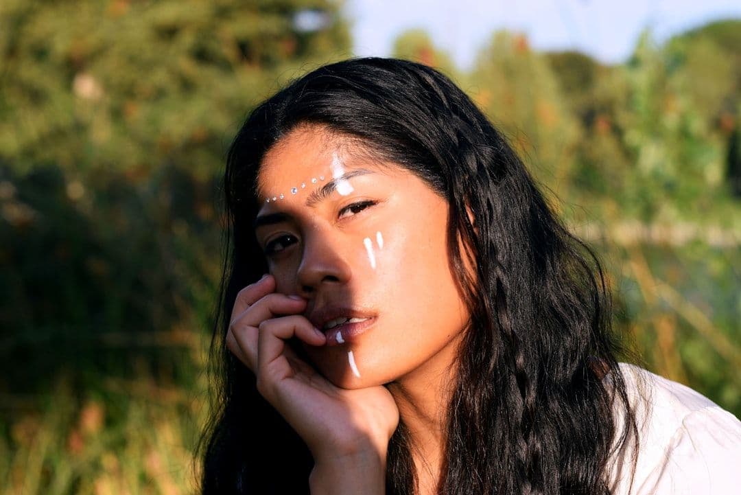 a woman with white paint on her face